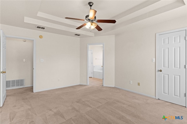 3102 Wisteria Ln, Killeen, TX 76549 - unfurnished bedroom with light colored carpet, a raised ceiling, ensuite bathroom, and a ceiling fan