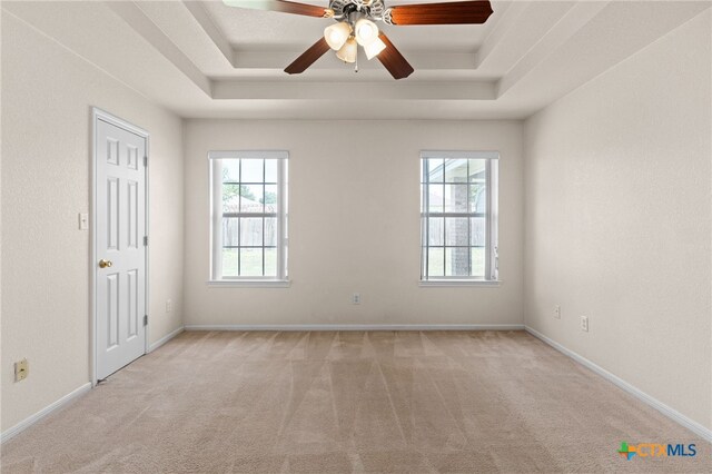 3102 Wisteria Ln, Killeen, TX 76549 - carpeted empty room with a tray ceiling, healthy amount of natural light, and a ceiling fan