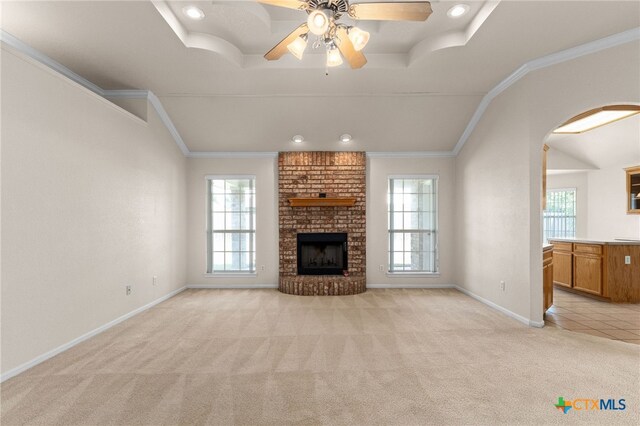 3102 Wisteria Ln, Killeen, TX 76549 - unfurnished living room with healthy amount of natural light, light colored carpet, a ceiling fan, a fireplace, and crown molding