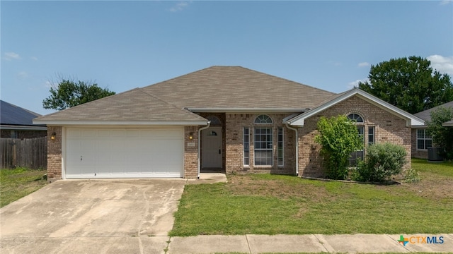 3102 Wisteria Ln, Killeen, TX 76549 - ranch-style home featuring an attached garage, brick siding, driveway, and a shingled roof