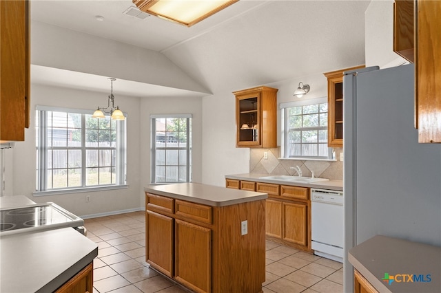 3102 Wisteria Ln, Killeen, TX 76549 - kitchen featuring white appliances, plenty of natural light, light tile patterned floors, lofted ceiling, and a kitchen island