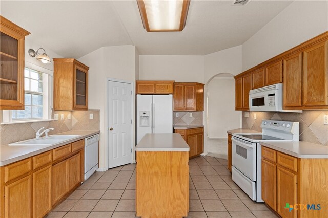 3102 Wisteria Ln, Killeen, TX 76549 - kitchen with white appliances, a center island, decorative backsplash, and light countertops