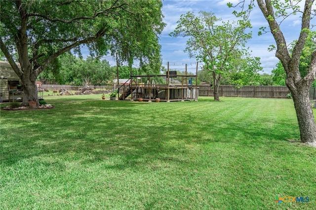 108 Elaine St, Victoria, TX 77904 - view of yard with stairs, a fenced backyard, and a deck