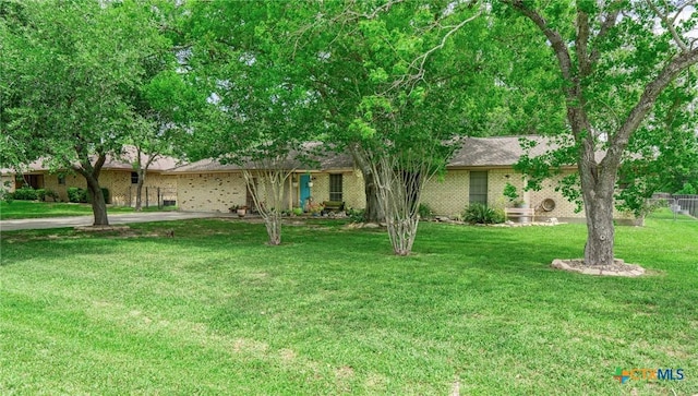108 Elaine St, Victoria, TX 77904 - view of front of home with a front lawn, brick siding, and fence