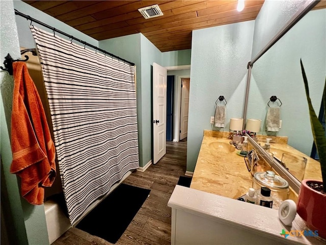 108 Elaine St, Victoria, TX 77904 - full bath featuring wood finished floors, visible vents, vanity, wooden ceiling, and baseboards