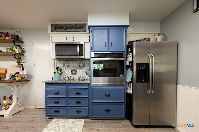 108 Elaine St, Victoria, TX 77904 - kitchen with stainless steel appliances, backsplash, light wood-style floors, blue cabinetry, and open shelves