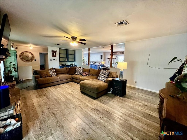 108 Elaine St, Victoria, TX 77904 - living room featuring wood finished floors, visible vents, baseboards, and ceiling fan