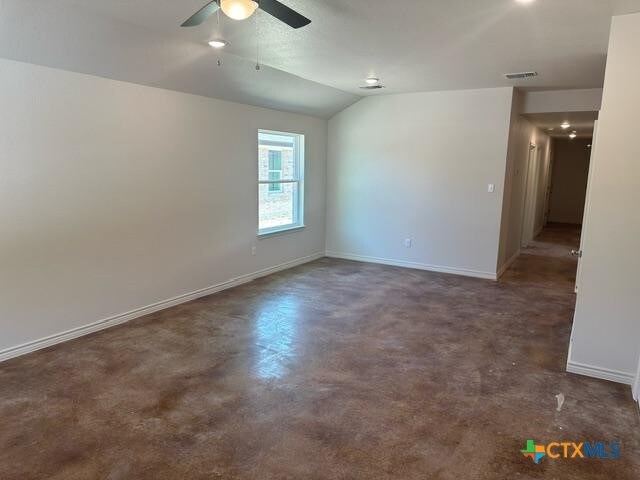 spare room with lofted ceiling and ceiling fan