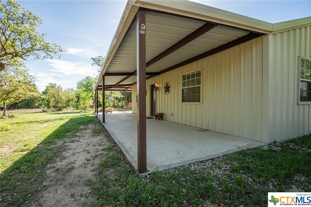 view of home's exterior featuring a patio area and a lawn