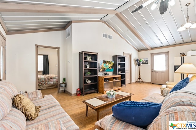 living room with ceiling fan, light hardwood / wood-style flooring, and lofted ceiling with beams