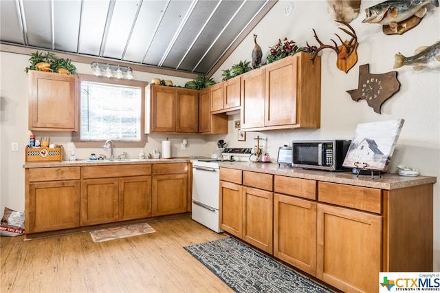 kitchen with vaulted ceiling, sink, light wood-type flooring, and white range with electric stovetop