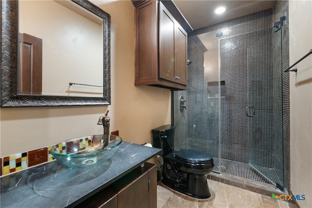 bathroom with a stall shower, vanity, and toilet