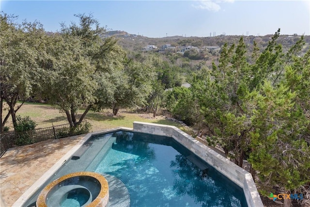 view of pool featuring an in ground hot tub