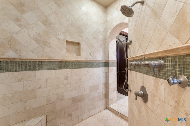 interior details featuring a tile shower