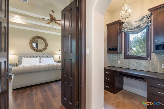 interior space featuring open floor plan, ornamental molding, decorative backsplash, dark countertops, and a raised ceiling