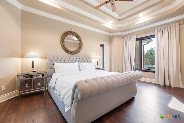 bedroom with baseboards, a raised ceiling, hardwood / wood-style flooring, ceiling fan, and ornamental molding