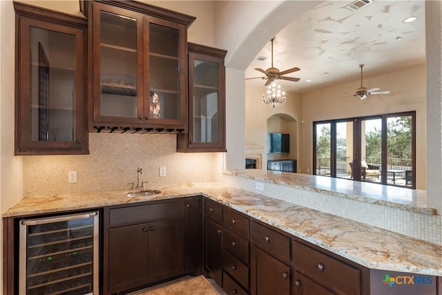 bar with ceiling fan, beverage cooler, a sink, visible vents, and decorative backsplash