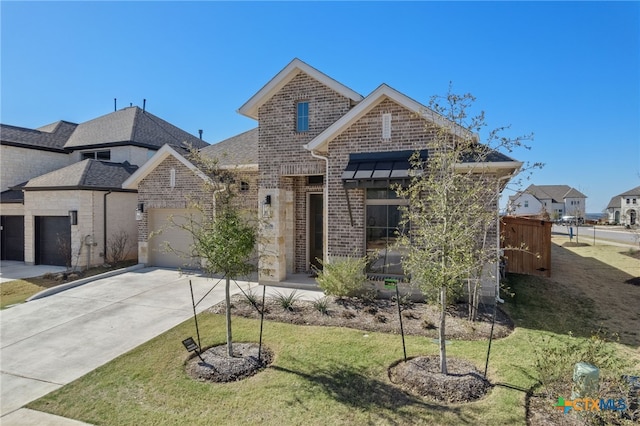 view of front of property with driveway, a garage, brick siding, fence, and a front yard