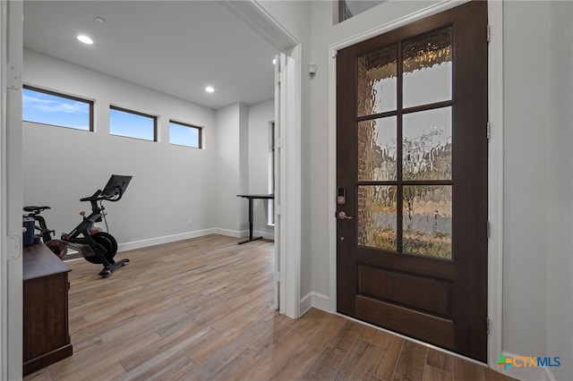 interior space with recessed lighting, baseboards, and wood finished floors