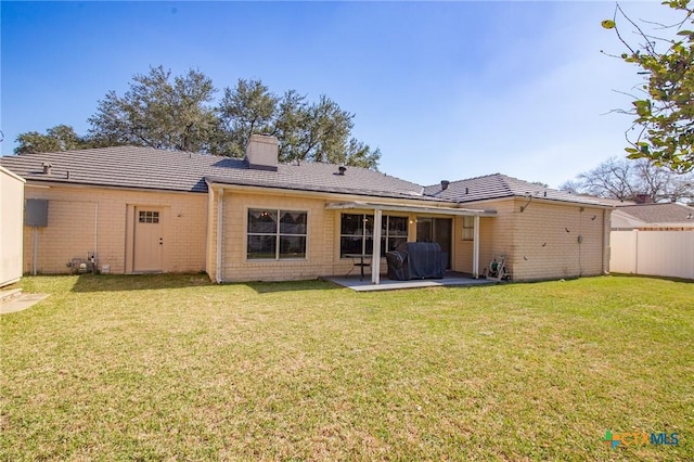 114 Berkshire Ln, Victoria, TX 77904 - rear view of property featuring a chimney, a patio, and brick siding