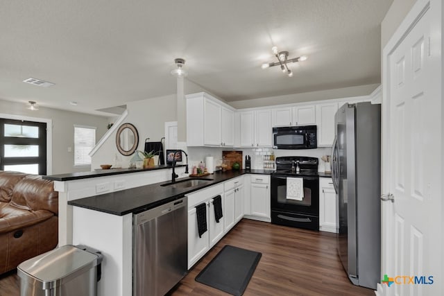 kitchen featuring sink, white cabinetry, dark hardwood / wood-style floors, kitchen peninsula, and black appliances