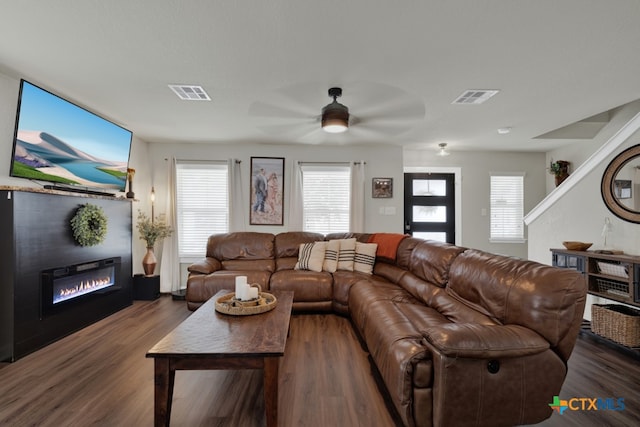 living room with ceiling fan and dark hardwood / wood-style flooring