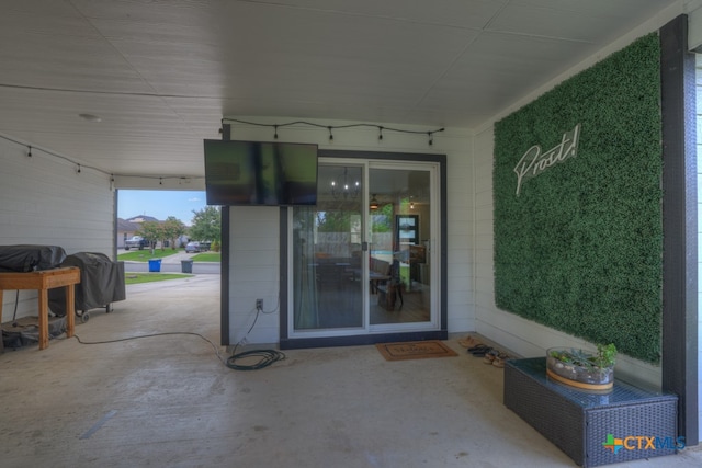 view of exterior entry with a patio