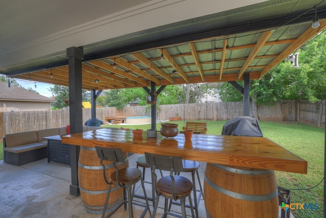 view of patio featuring a pool and exterior bar