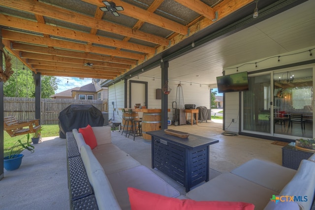 view of patio featuring a bar, a grill, and outdoor lounge area