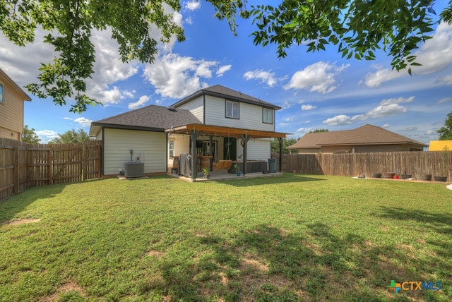 back of house featuring a patio, central AC unit, and a lawn