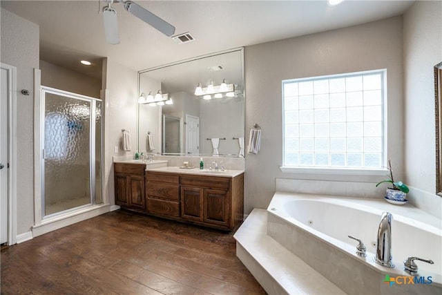 bathroom with vanity, hardwood / wood-style flooring, independent shower and bath, and ceiling fan