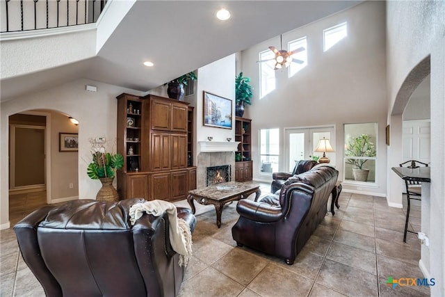 living room with a high ceiling and light tile patterned floors