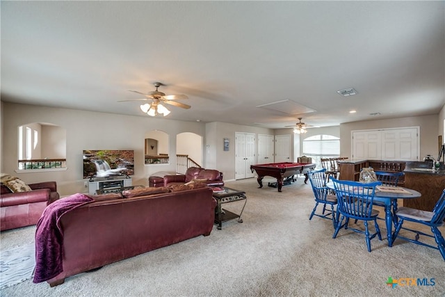 carpeted living room with ceiling fan, pool table, and sink