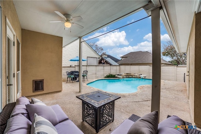 view of swimming pool featuring a patio, an outdoor living space with a fire pit, and ceiling fan