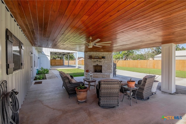 view of patio / terrace with an outdoor stone fireplace and ceiling fan