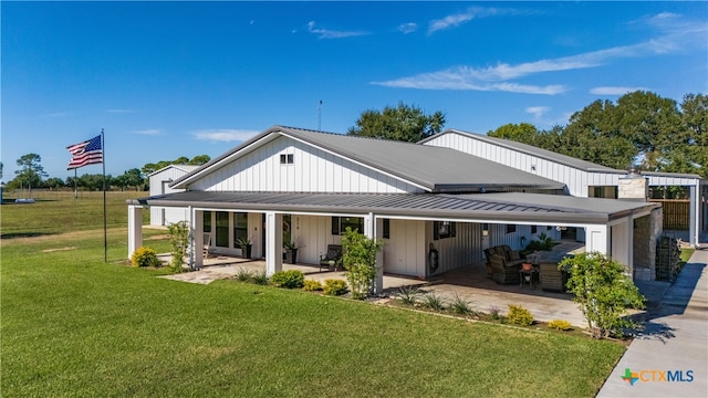 rear view of property featuring a yard