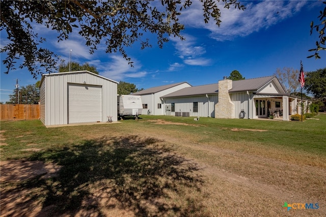 rear view of house with an outbuilding, a yard, and a garage