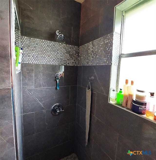 bathroom with a tile shower