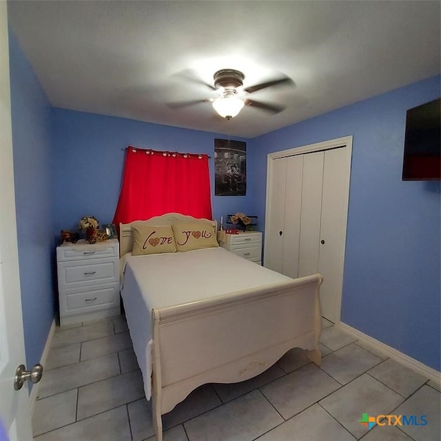 tiled bedroom with a closet and ceiling fan