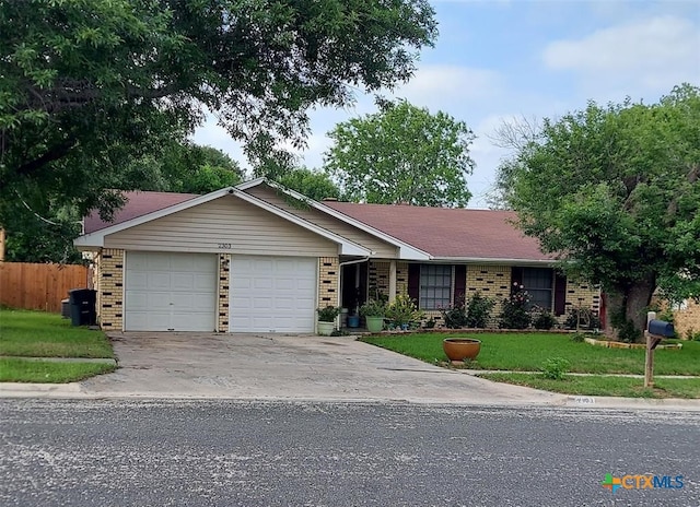 ranch-style home with a garage and a front lawn