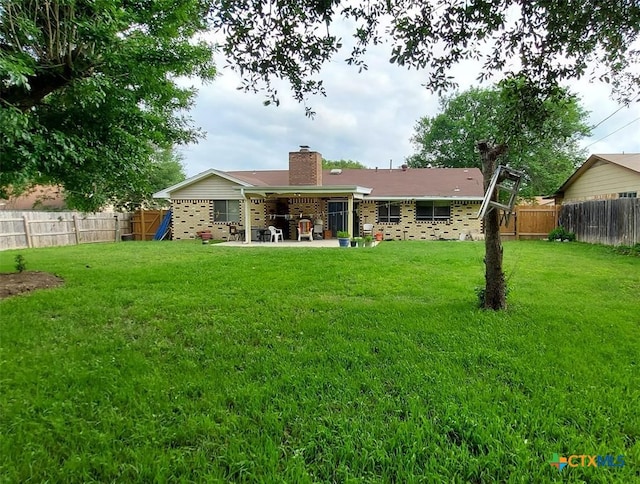 back of house featuring a yard and a patio area