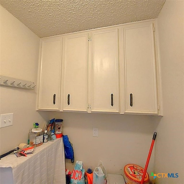 laundry area with a textured ceiling