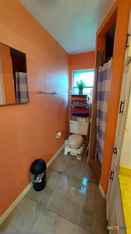 bathroom featuring tile patterned floors and toilet