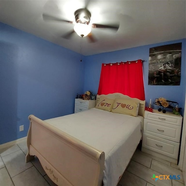 tiled bedroom with ceiling fan