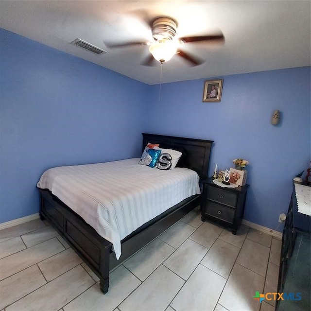 tiled bedroom featuring ceiling fan