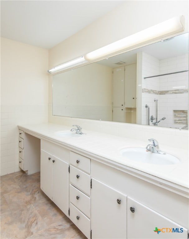 bathroom with tile walls and vanity