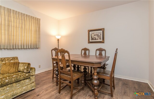 dining space featuring dark hardwood / wood-style flooring