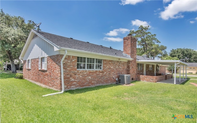 back of property featuring central AC, a yard, and a patio area