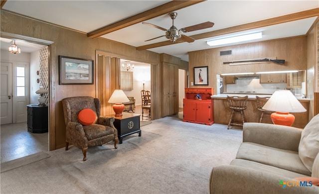 interior space with wooden walls, beamed ceiling, and ceiling fan