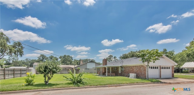 view of front of home with a front yard and a garage